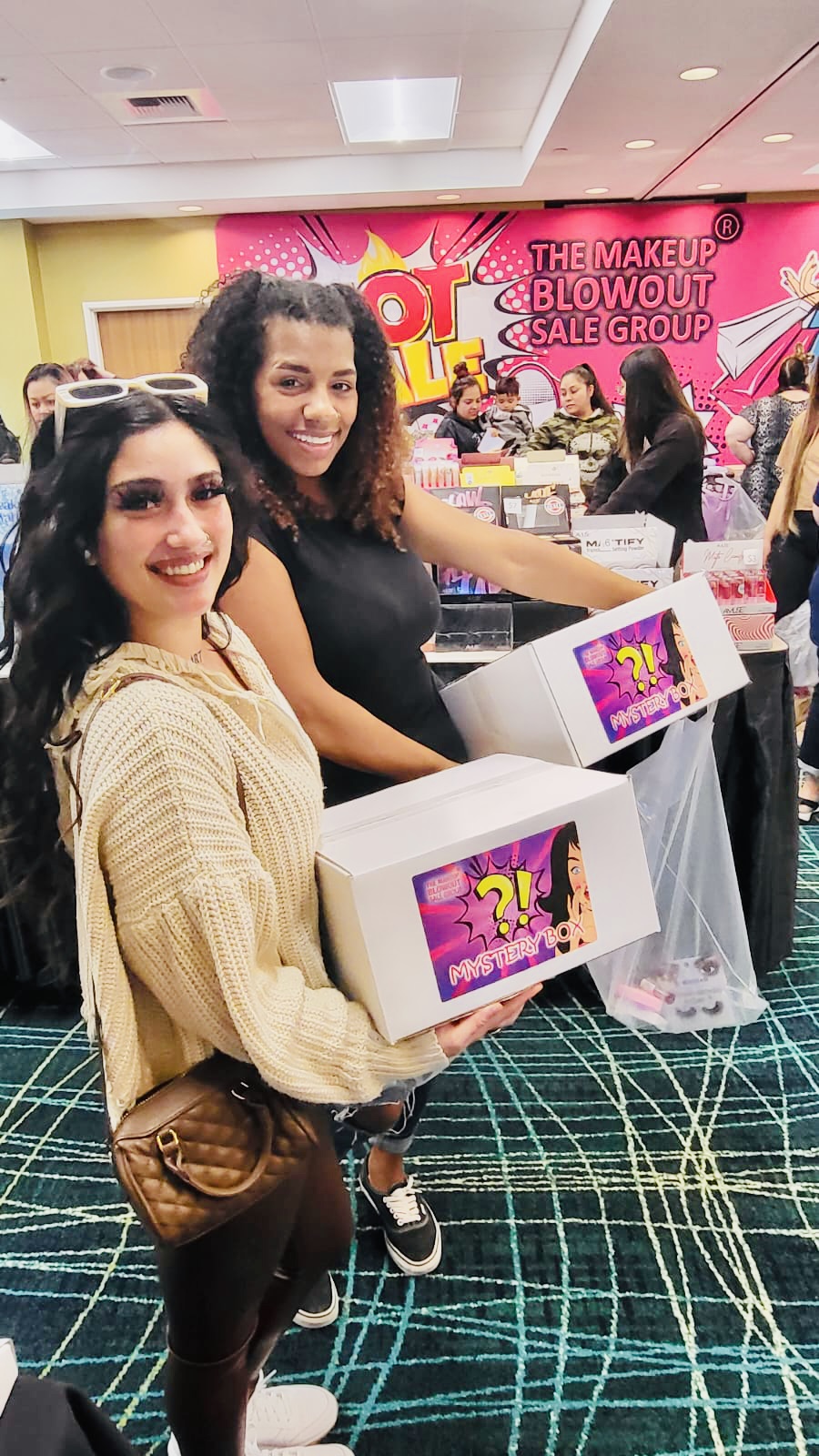 Two happy customers holding mystery boxes