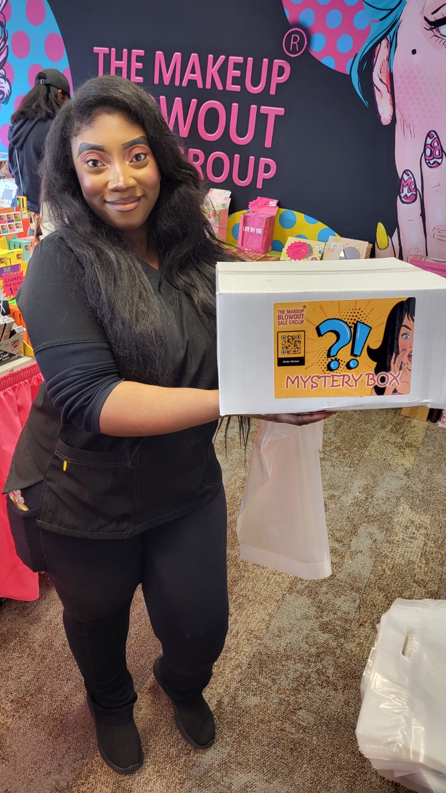 Customer holding a mystery box at the booth