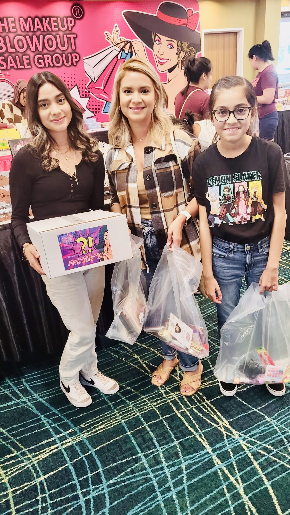 Three customers with mystery box and bags