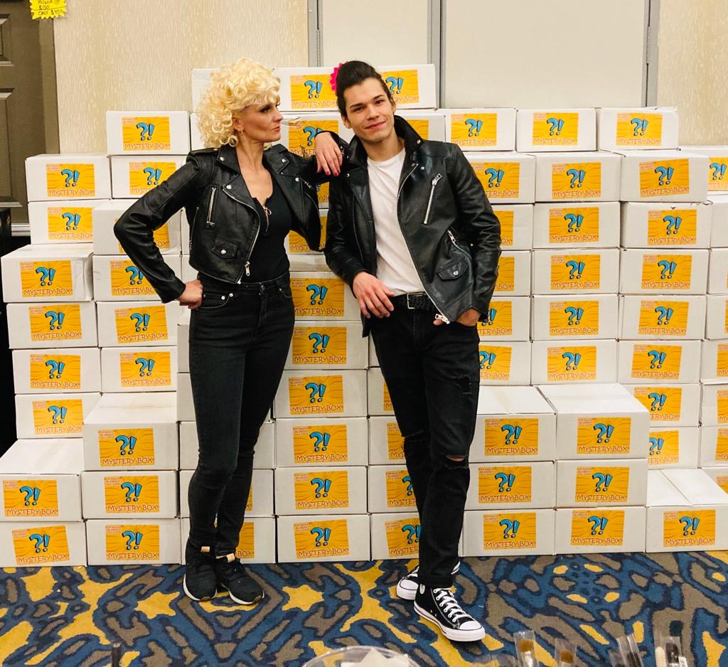 Two customers in leather jackets by a wall of mystery boxes