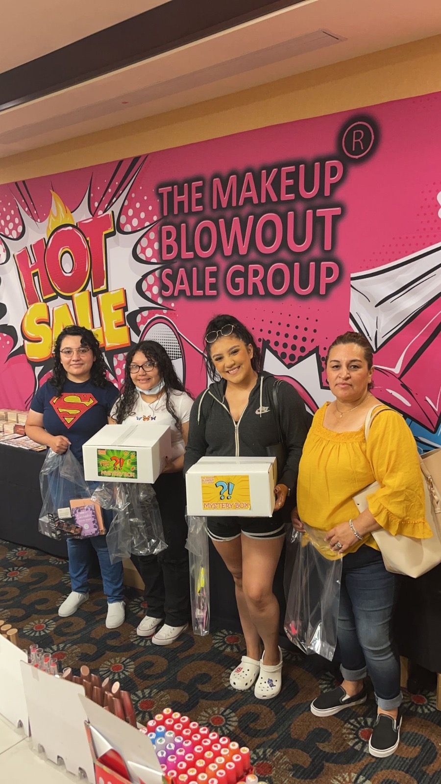 Four customers with mystery boxes at the Hot Sale wall